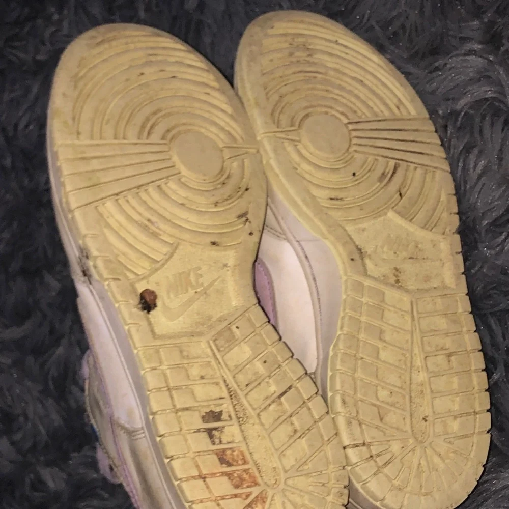Well worn women’s Nike White dunks sneakers with Light Purple Accents WW